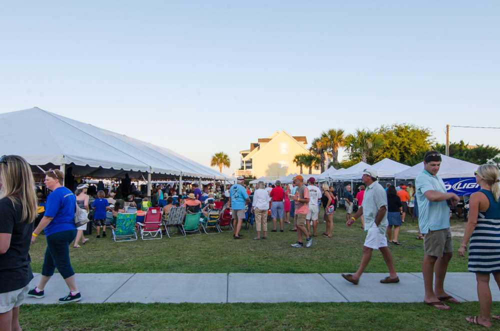 People mulling around at an outdoor event.