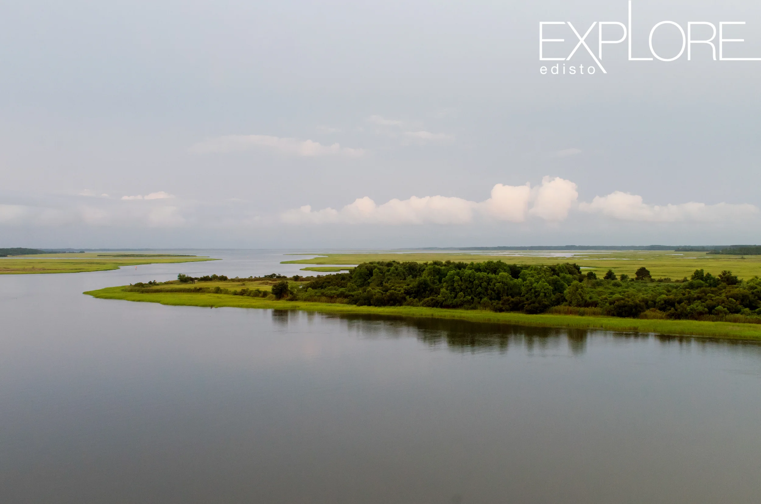 Creek and marshland on a dreary day with clouds.
