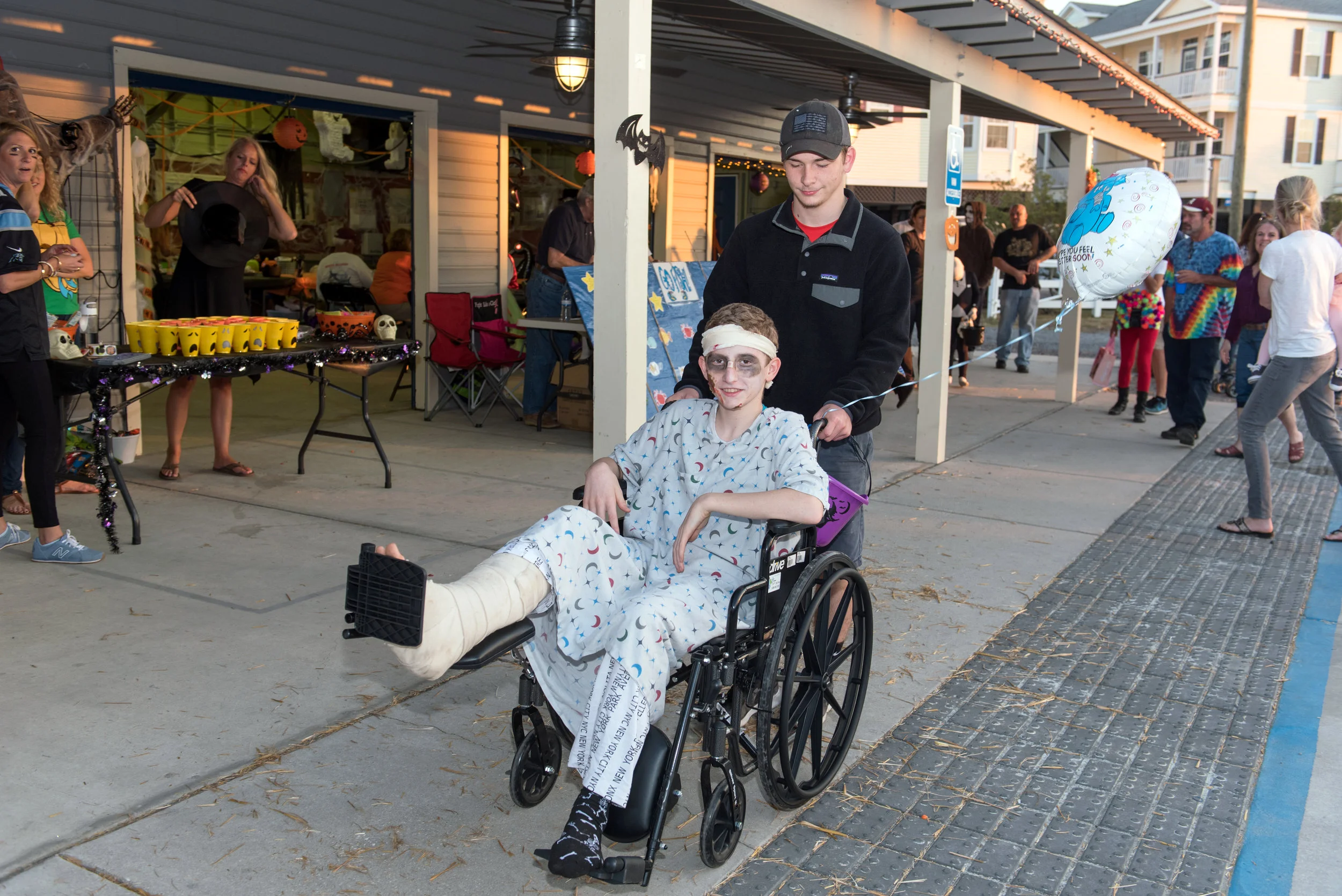 Young person in wheelchair dressed as a zombie.