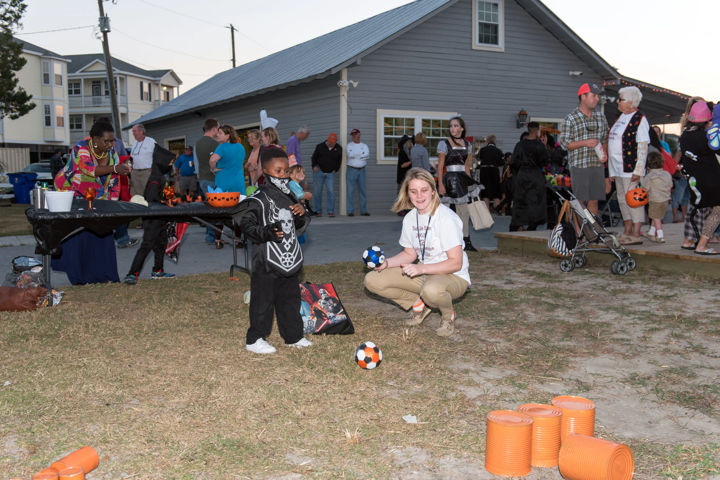 Boy in costume plays game at Halloween Festival.