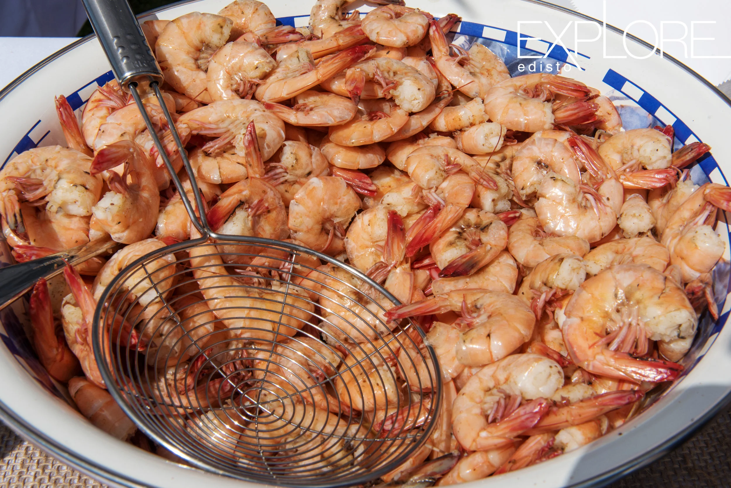 A large bowl of cooked peel and eat shrimp.