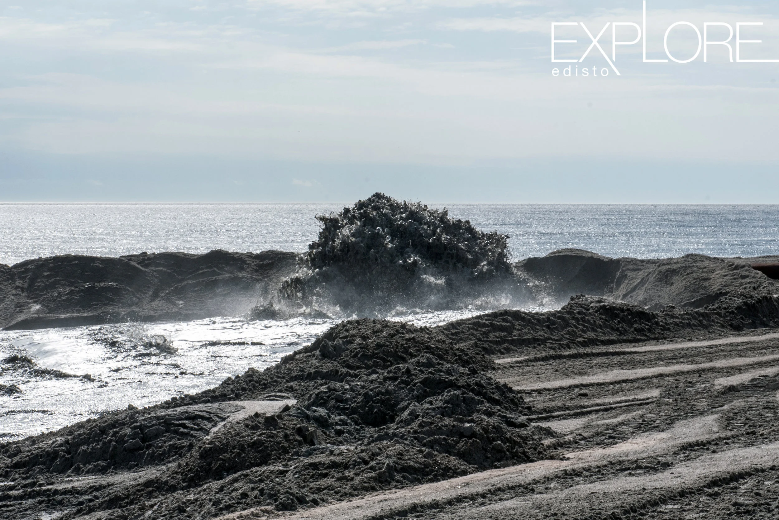An explosion of sand as it is blasted onto the beach during beach nourishment at Edisto Beach, SC.