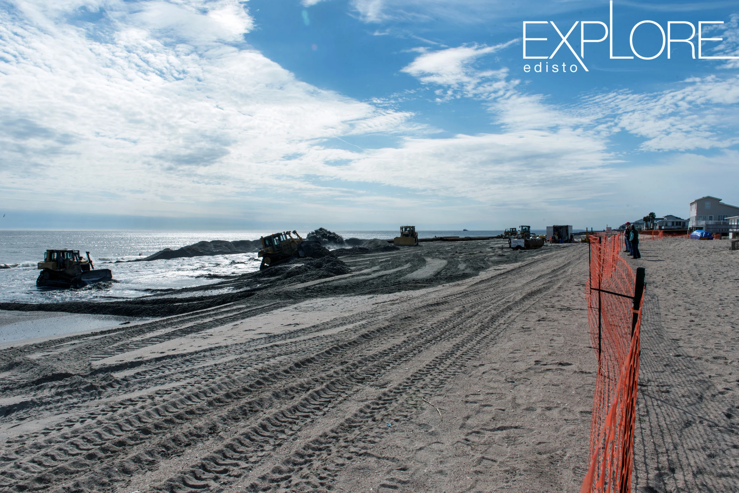 Orange fencing marks a work area during beach renourishment.