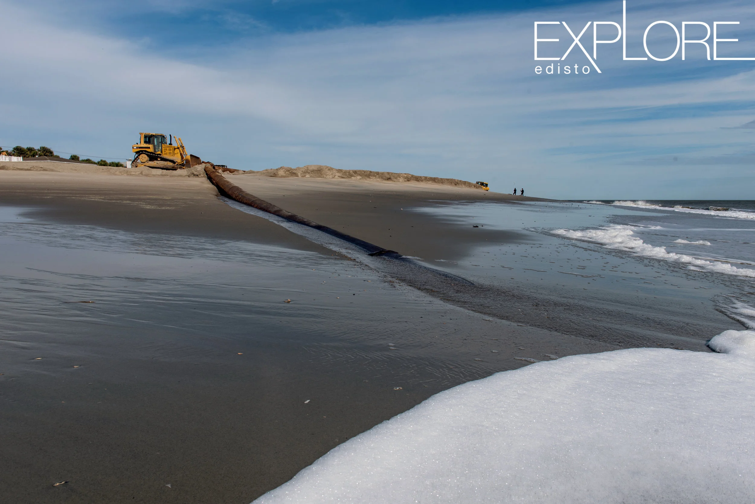 Sea foam and pipeline running from the ocean during beach renourishment.