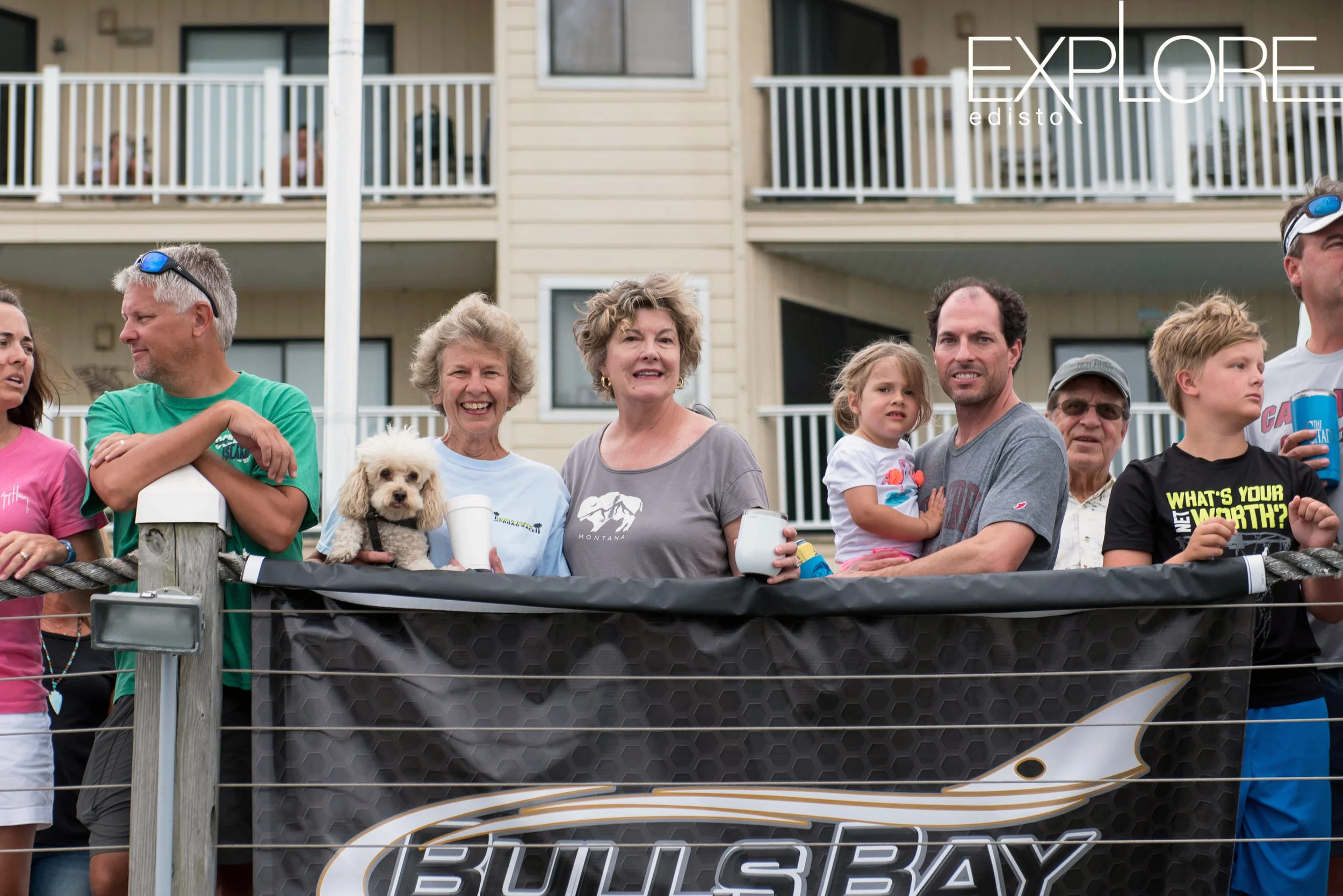 Lady and poodle pose with crowd on dock at the Marina at Edisto Beach.