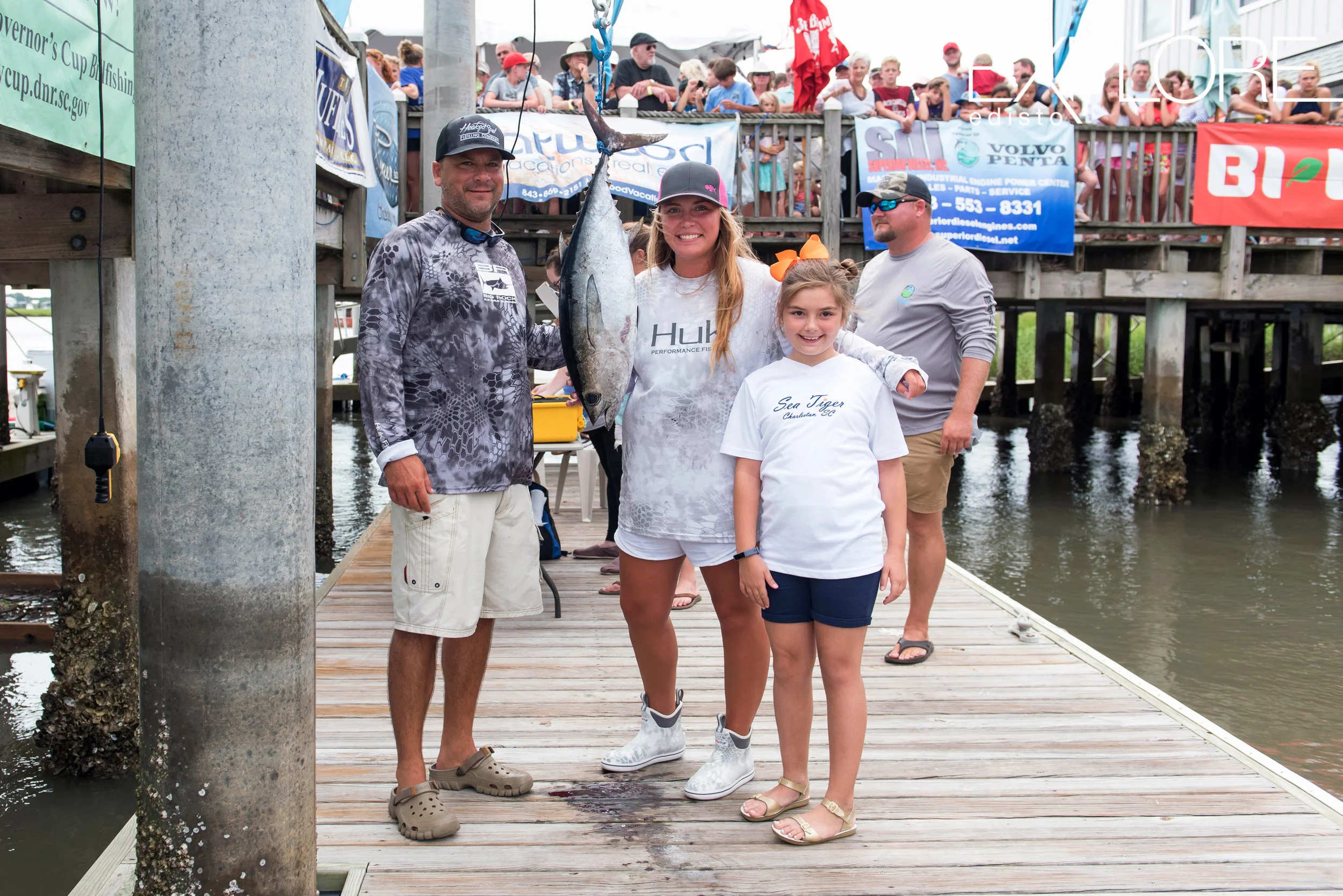 Couple and young girl pose with tuna on dock at the Marina at Edisto Beach.