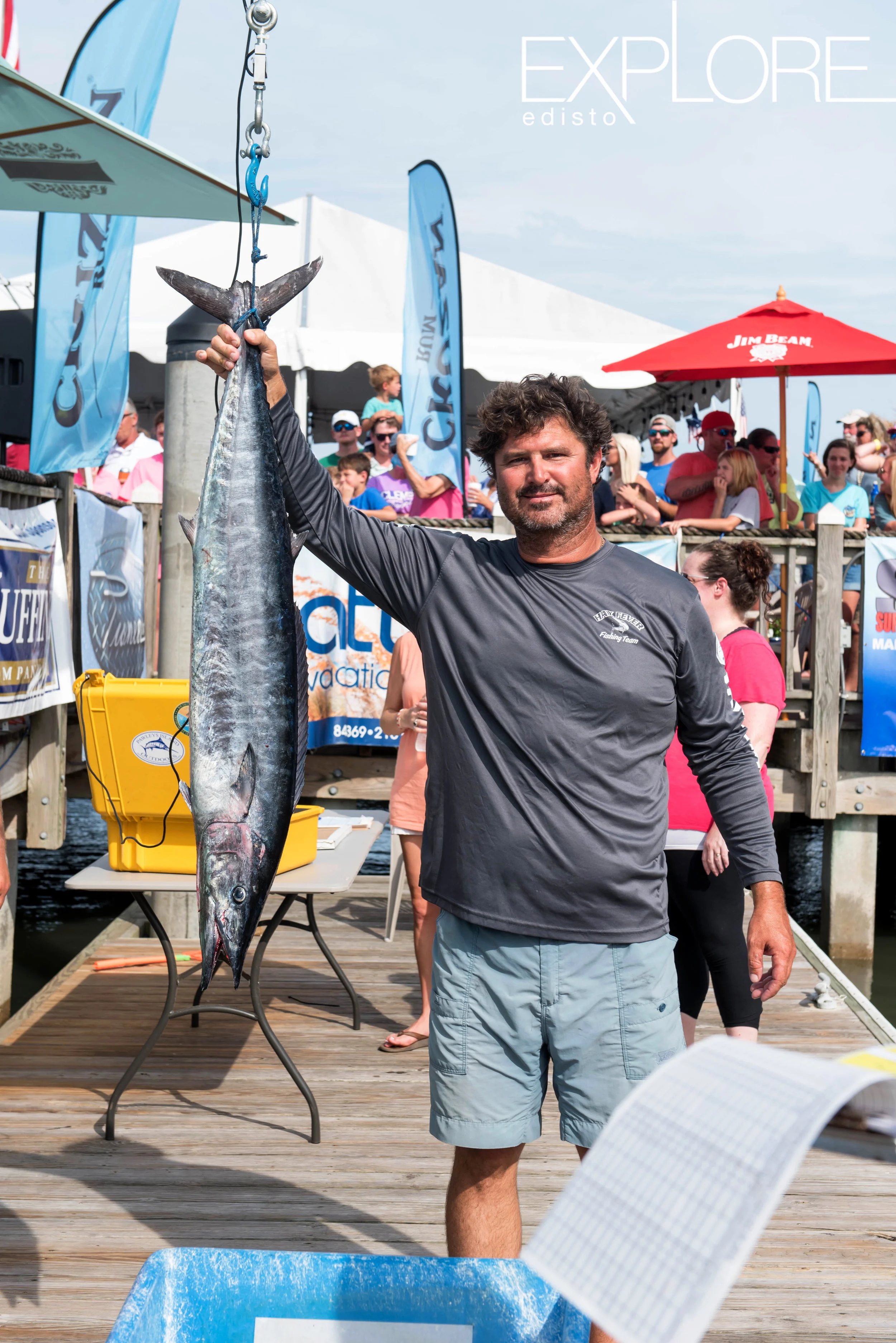 Man in gray shirt poses with wahoo.