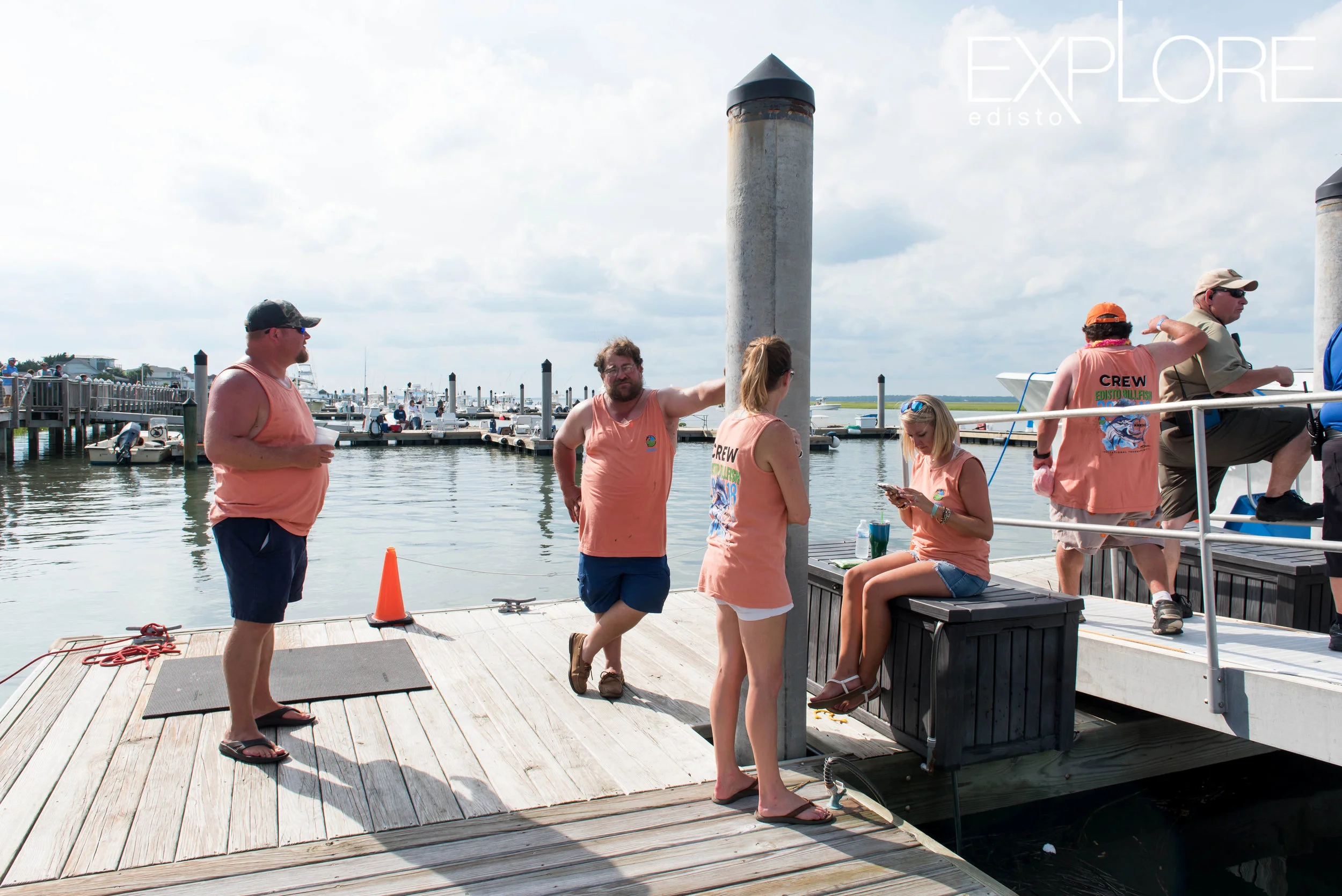 Crew at the Marina at Edisto Beach wearing orange shirts on the dock.