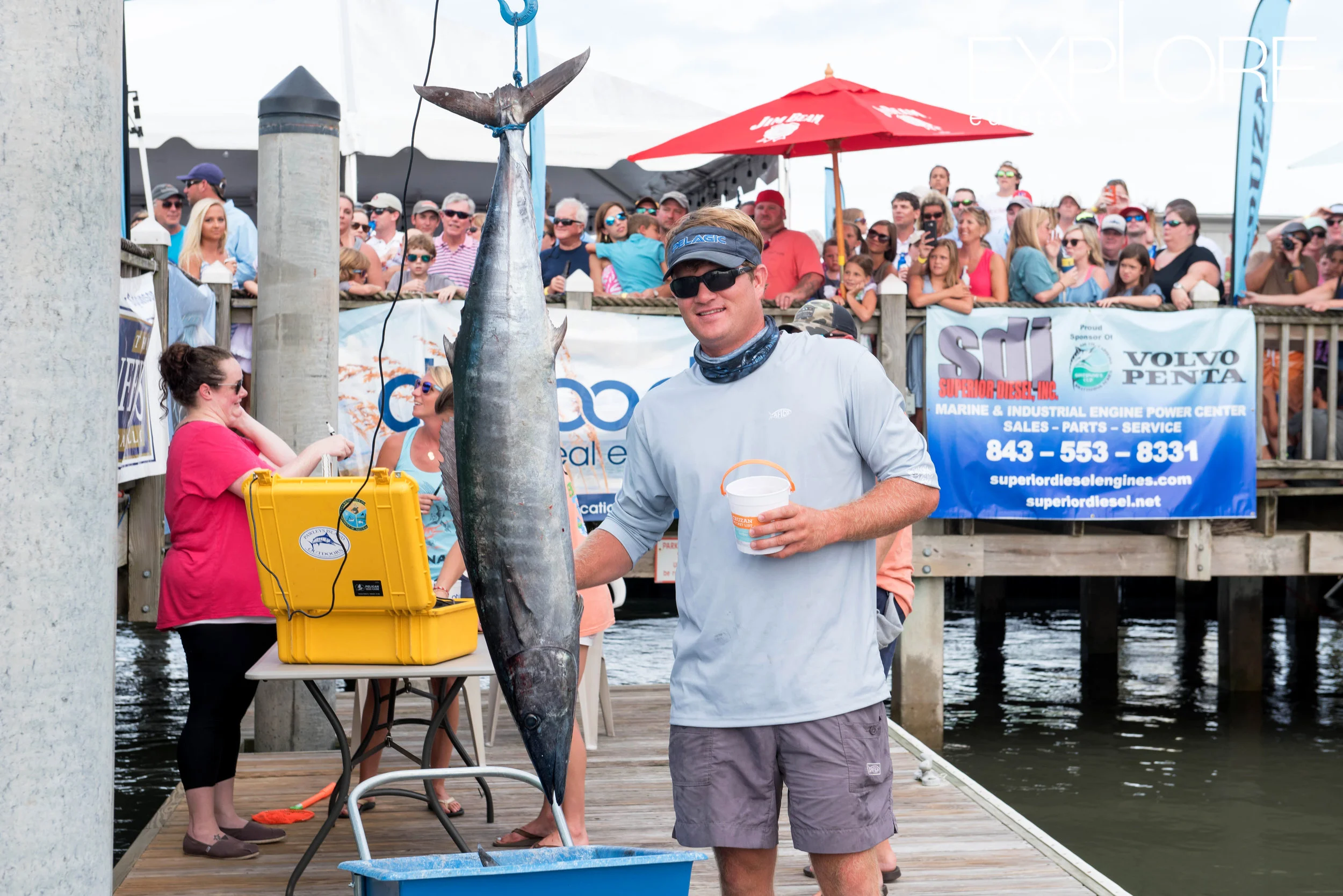 Guy in visor poses with wahoo.