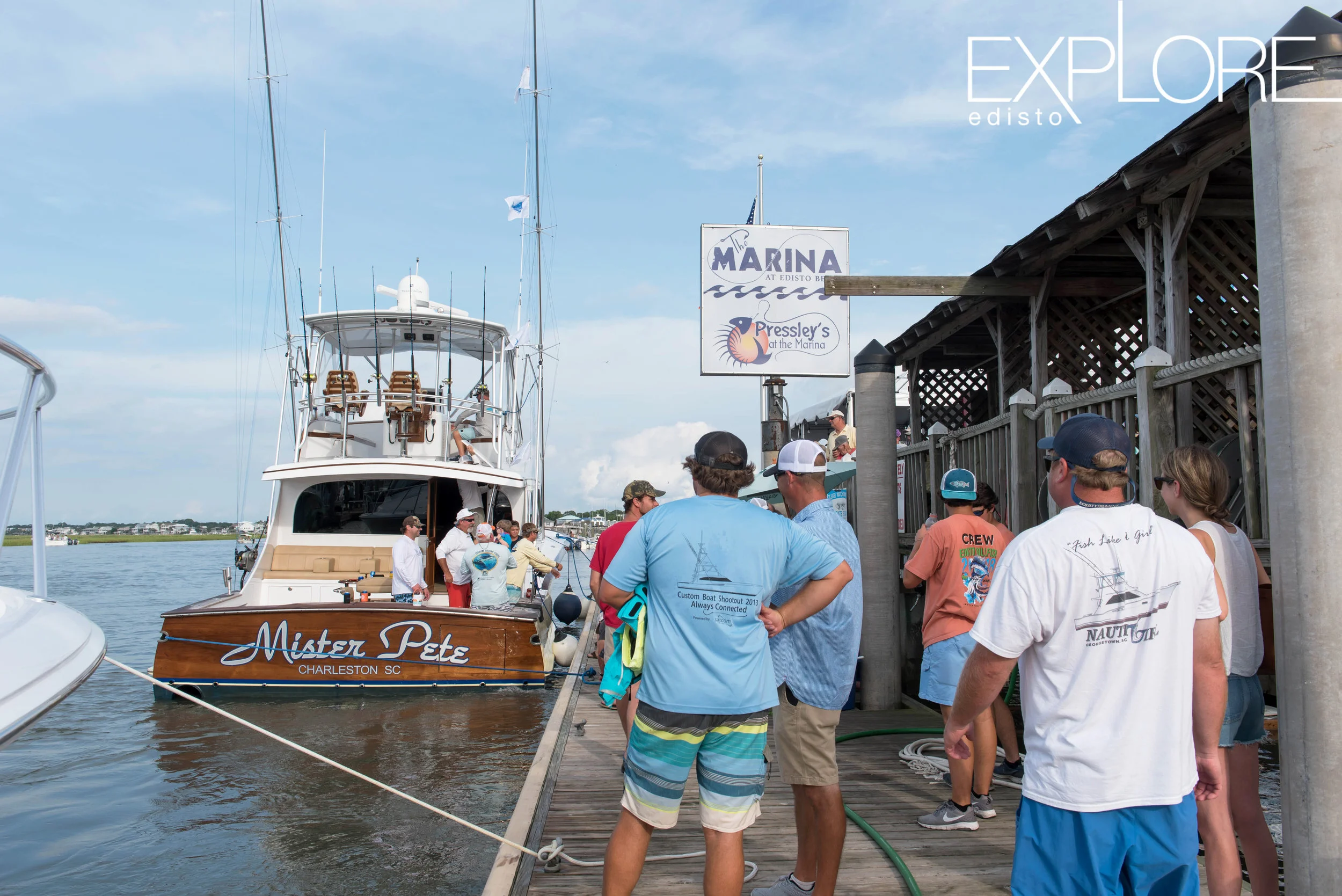 Large boat named Mister Pete at the fuel dock next to The Marina at Edisto Beach sign.