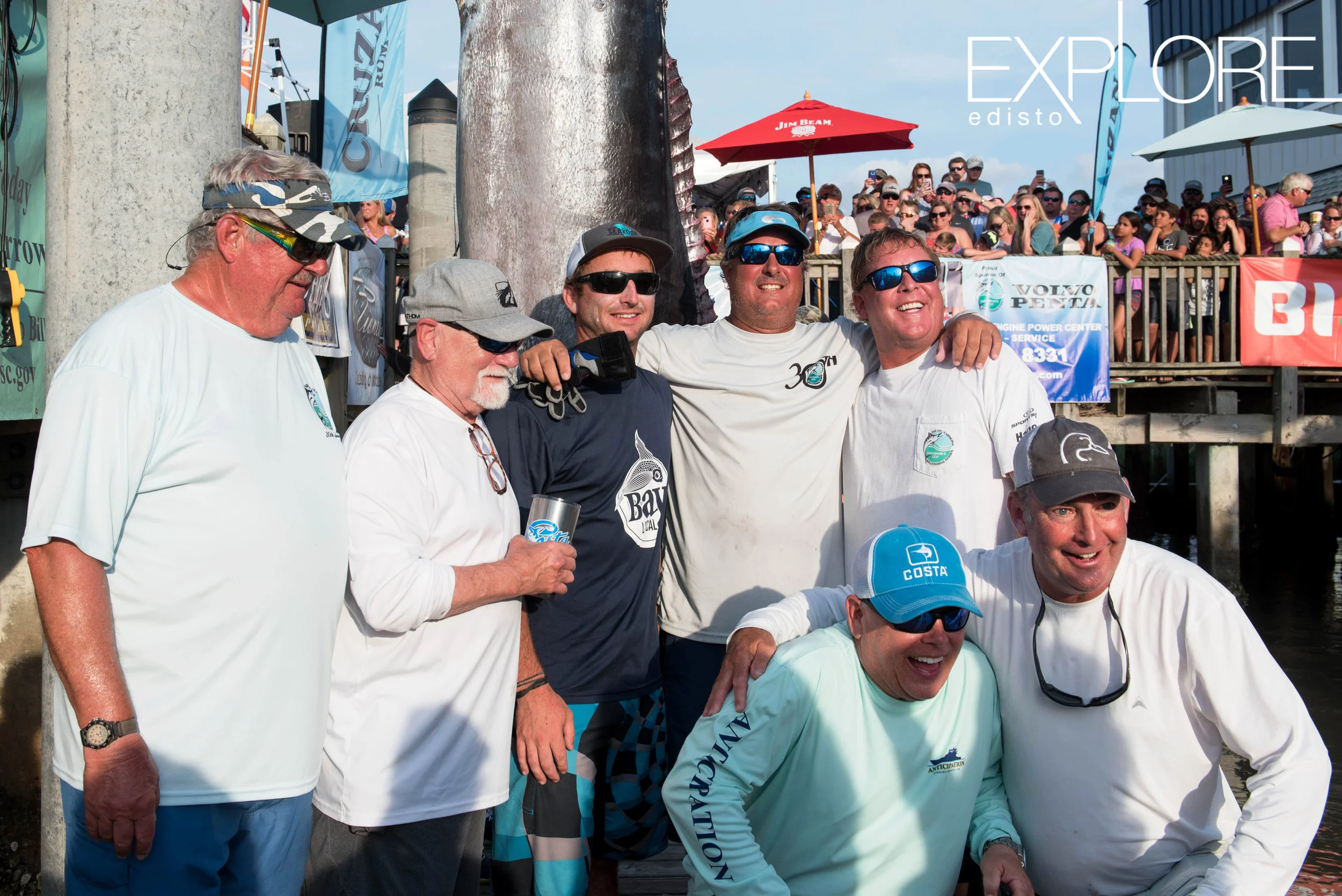 Men posing with massively large marlin.