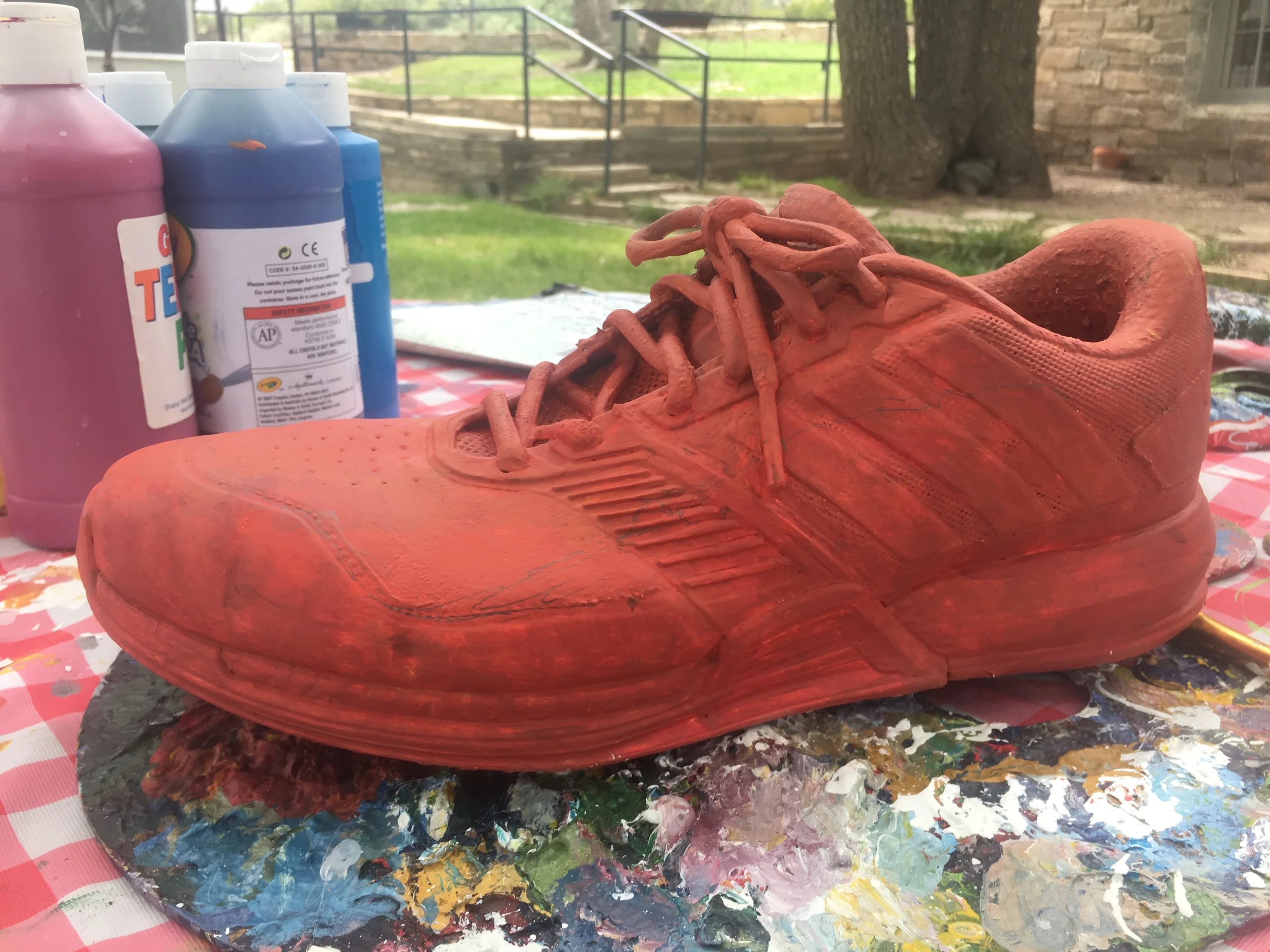 Step 3: Lay a ground color down. I usually look at the landscape I'm about to paint and figure out what the main colors are. There were lots of greens and purples in my scene, so I used the complimentary color of green (red) as a base layer. This way, if my paint is less opaque in areas the red will peak through and activate the painting! 