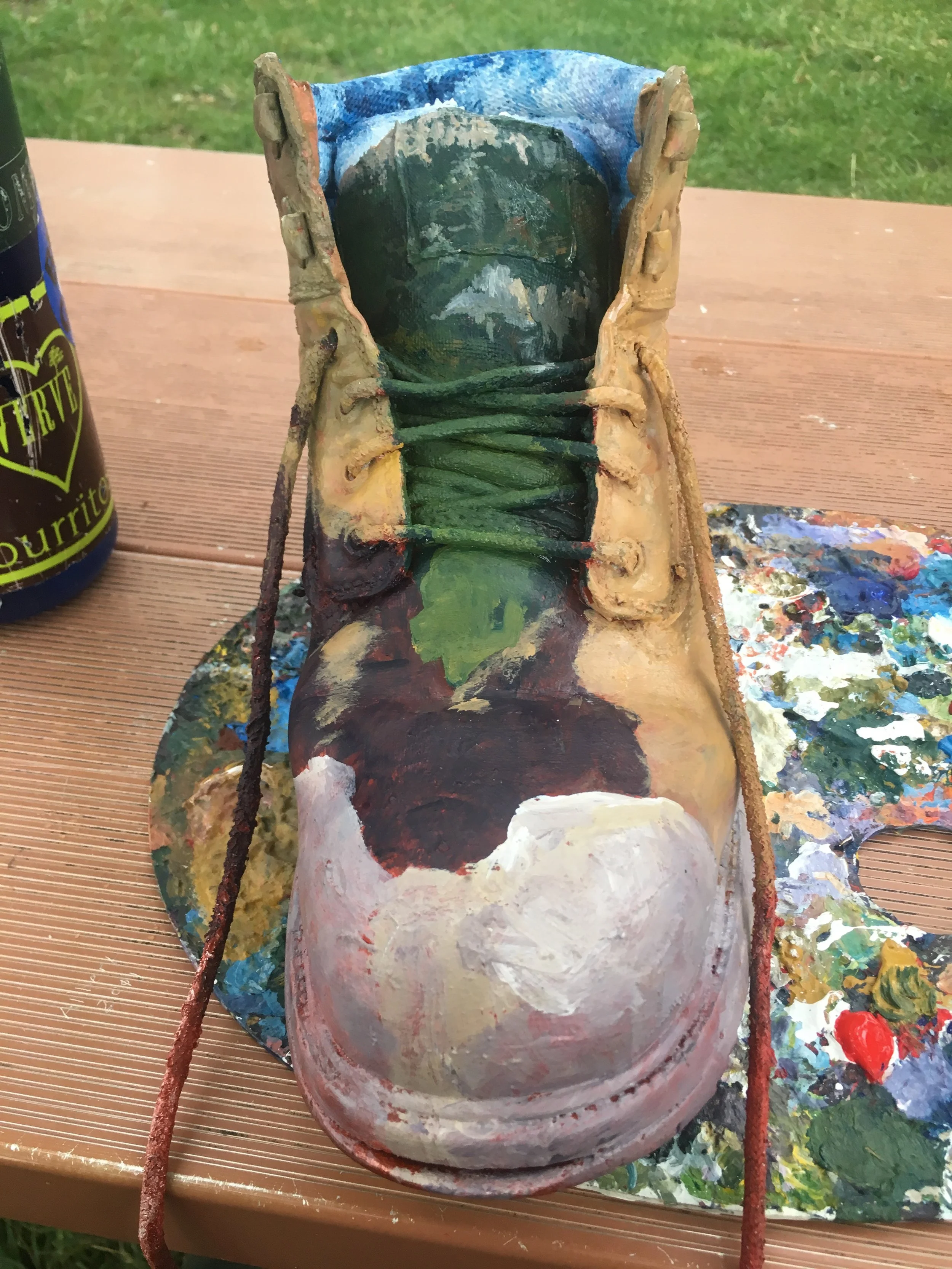 Some of the first few layers of paint. Loved working with the boot oriented forward- as if it is stepping right into the landscape!