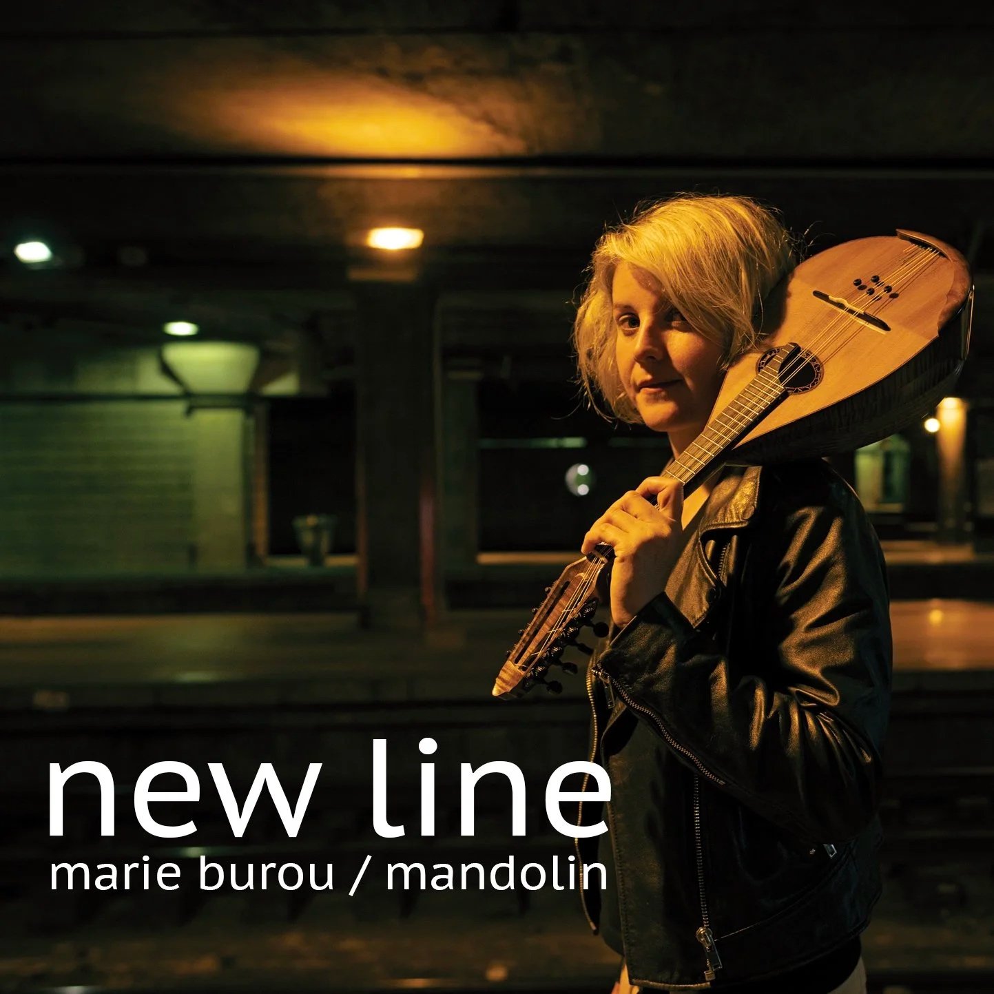 A woman with blonde hair holding a mandolin on her shoulder, standing in a dimly lit indoor space, with the words 'new line' and 'marie burou / mandolin' overlaid on the image.