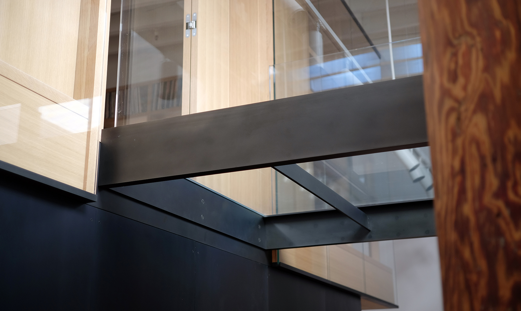  Blackened steel holds the glass bridge to the floating library… 