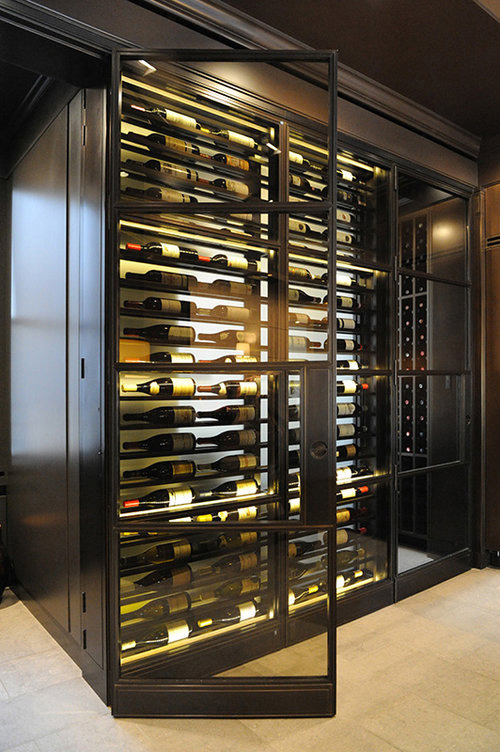  Bronze framed wine room with special hinges and handles engineered to allow flush-to-surface open. 