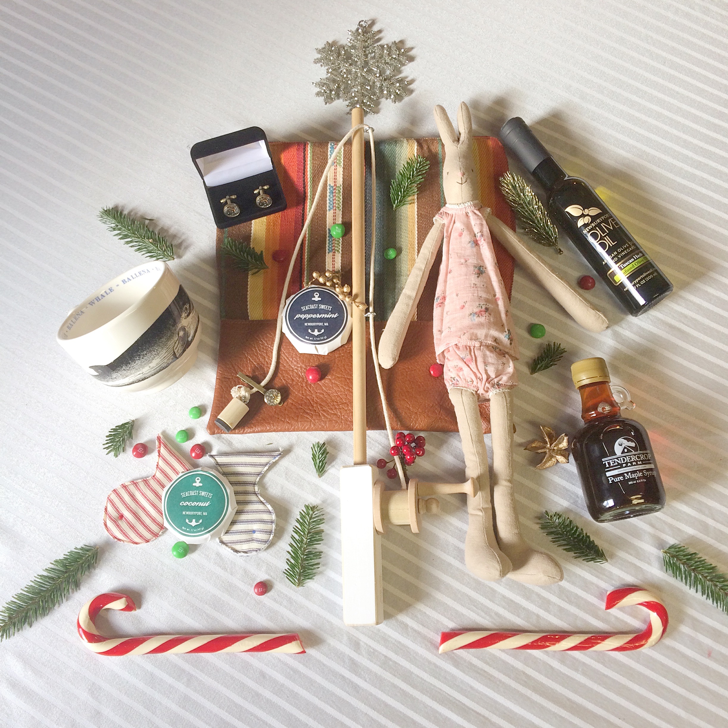 Fauna Whale Cup, Wish Basket $16.95. Seacoast Sweets Wish Basket/Sage Market & Design $3. Cufflinks, Farley's. Children's fishing rod, Piper & Chloe, $45.00 Rabbit doll, Piper & Chloe $38.00. Leather clutch, Vaalbara Supply, $132. Newburyport Tuscan Oil, Newburyport Olive Oil,$12. Pure maple syrup, Tendercrop Farm $10.00. Hammonds Candy Cane, Tendercrop Farm $3.