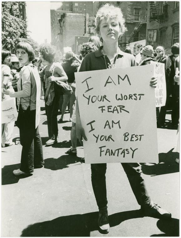  Donna Gottschalk holds poster "I am your worst fear I am your best fantasy" at Christopher Street Gay Liberation Day parade, 1970. Image courtesy the New York Public Library Digital Archives and Manuscripts.&nbsp;The reuse of this image has been per