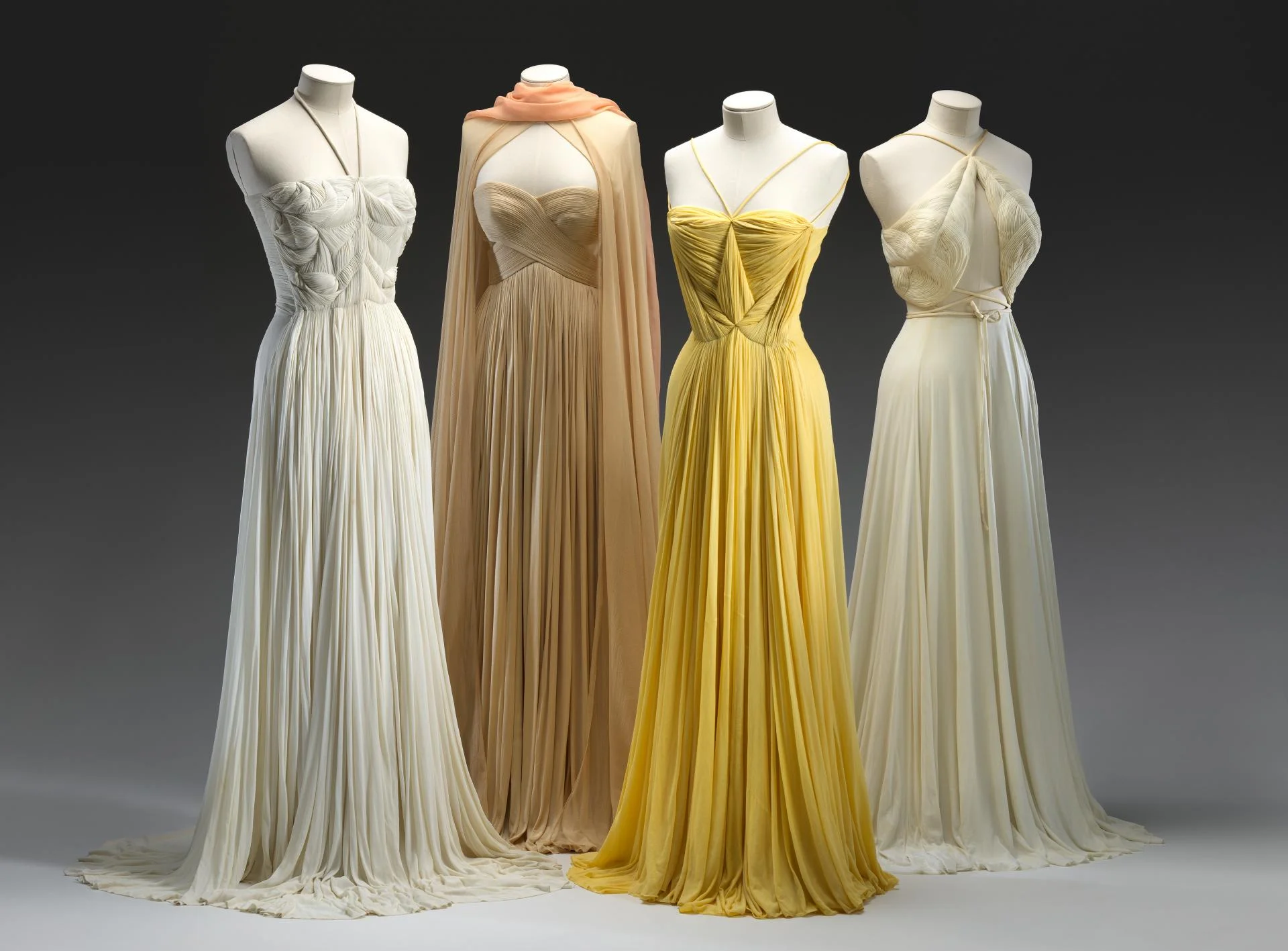 Evening dresses by Madame Grés for Alix Paris, 1939, from the collection of the National Gallery of Victoria, Melbourne. Purchased with funds donated by Mrs. Krystyna Campbell-Pretty in memory of Mr. Harold Campbell-Pretty, 2015. Courtesy of the National Gallery of Victoria.