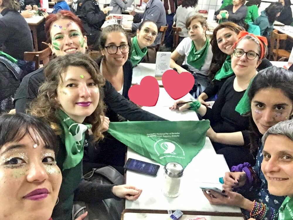  Candelaria B. with members of her organization after getting ready for a demonstration. A lot of glitter, green stickers, and green handkerchiefs around their necks. Most activist groups meet before a demonstration in order to remain together as it 