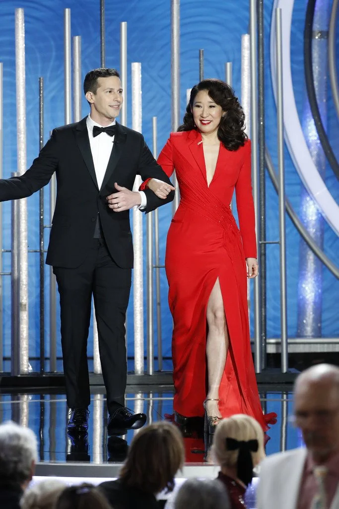 Golden Globes hosts Andy Samberg and Sandra Oh in Atelier Versace