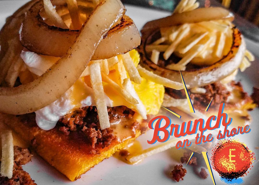Our Brittany Benedict will knock you off your feet! Fresh Medianoche (Sweet) Bread, Cuban style ground beef, Poached Egg, Creamy Tomato Hollandaise Sauce, Crispy Potato Sticks, topped with Caramelized Onions