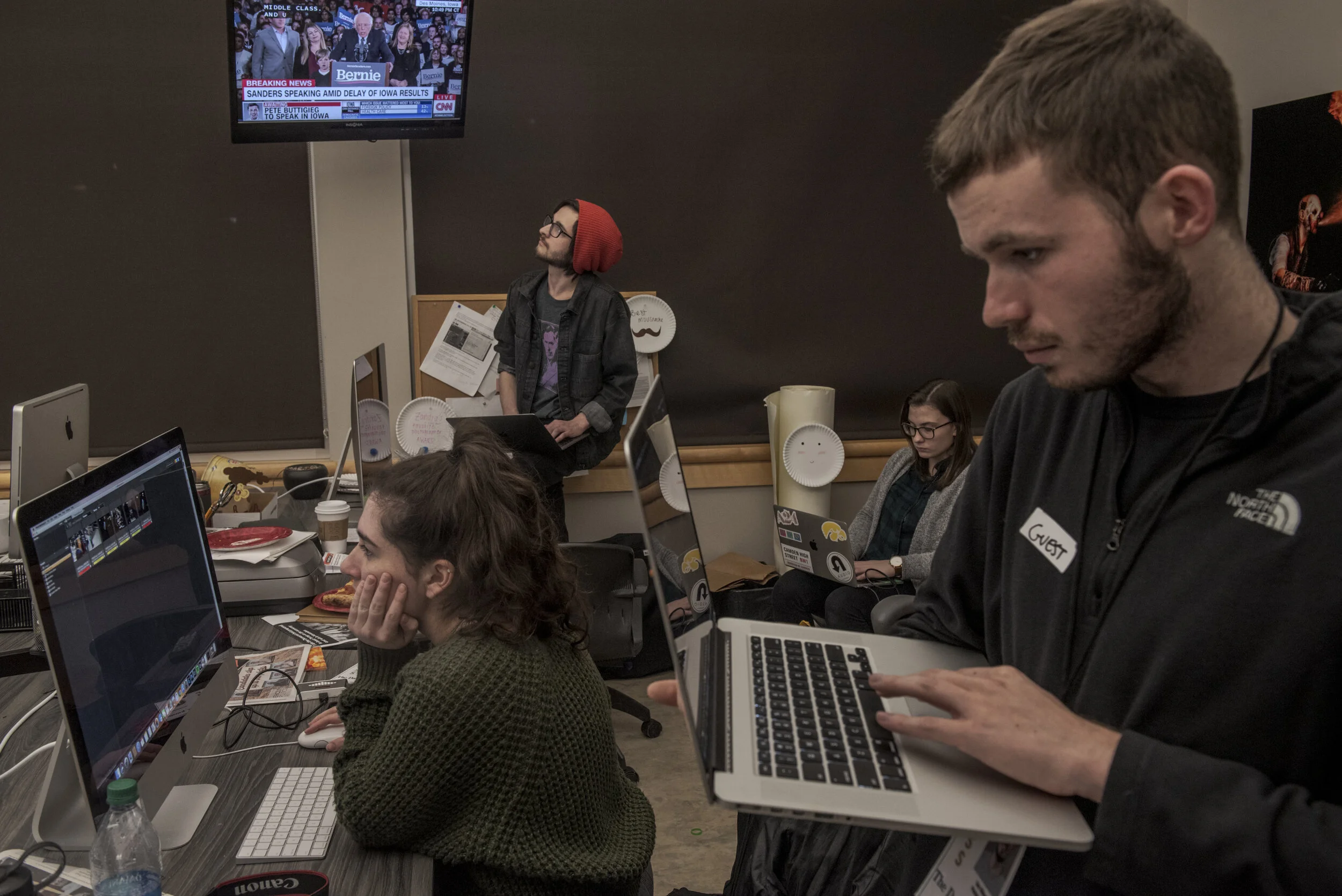  Members of the photo staff file and select photos for publication following the Iowa Caucus in the newsroom of the Daily Iowan, the University of Iowa's independent student newspaper, in Iowa City on Monday, Feb. 3, 2020. The Daily Iowan is produced