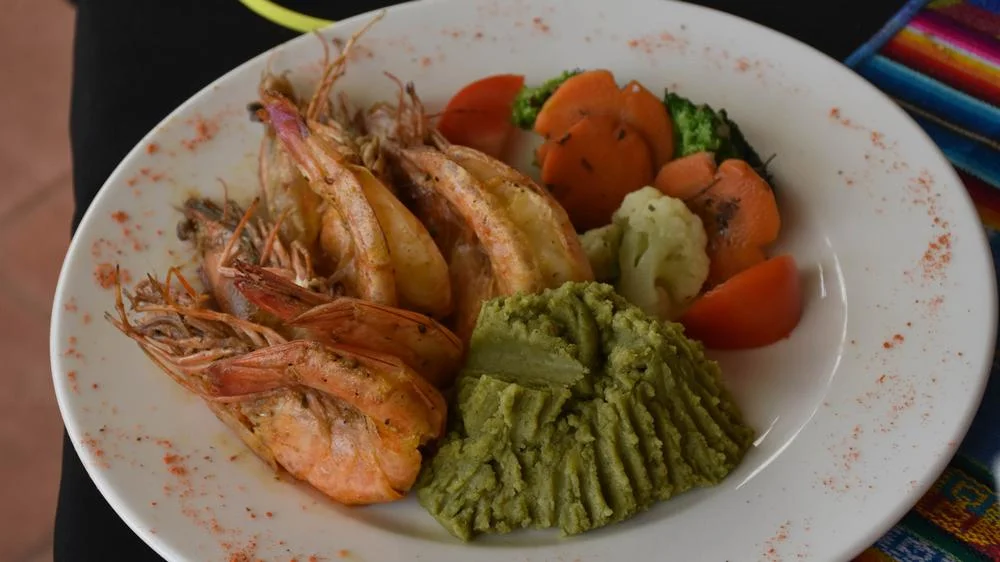 A dish of shrimp with mashed otoy.