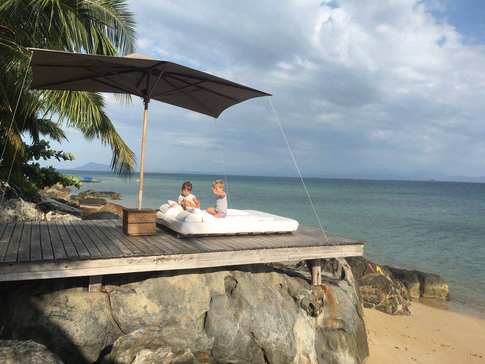 Couple relaxing on the deck on a rock at Tsara Komba Lodge