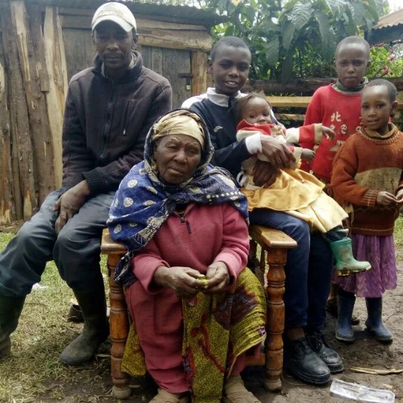 Joseph with his grandmother, uncle and cousins at his home in rural Kenya. 