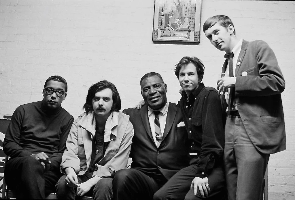 January 1967 - New York City -Cafe Au Go Go - Early Siegel-Schwall Band on tour with Howlin’ Wolf; Left to Right: Jack Myers (bass), Jim Schwall, Howlin’ Wolf, Me on Wolf’s knee, Russ Chadwick (drums) Wolf used to knock on Corky’s door every morning and they’d take walks in the Village. Wolf loved the idea of brining blues to classical audiences.