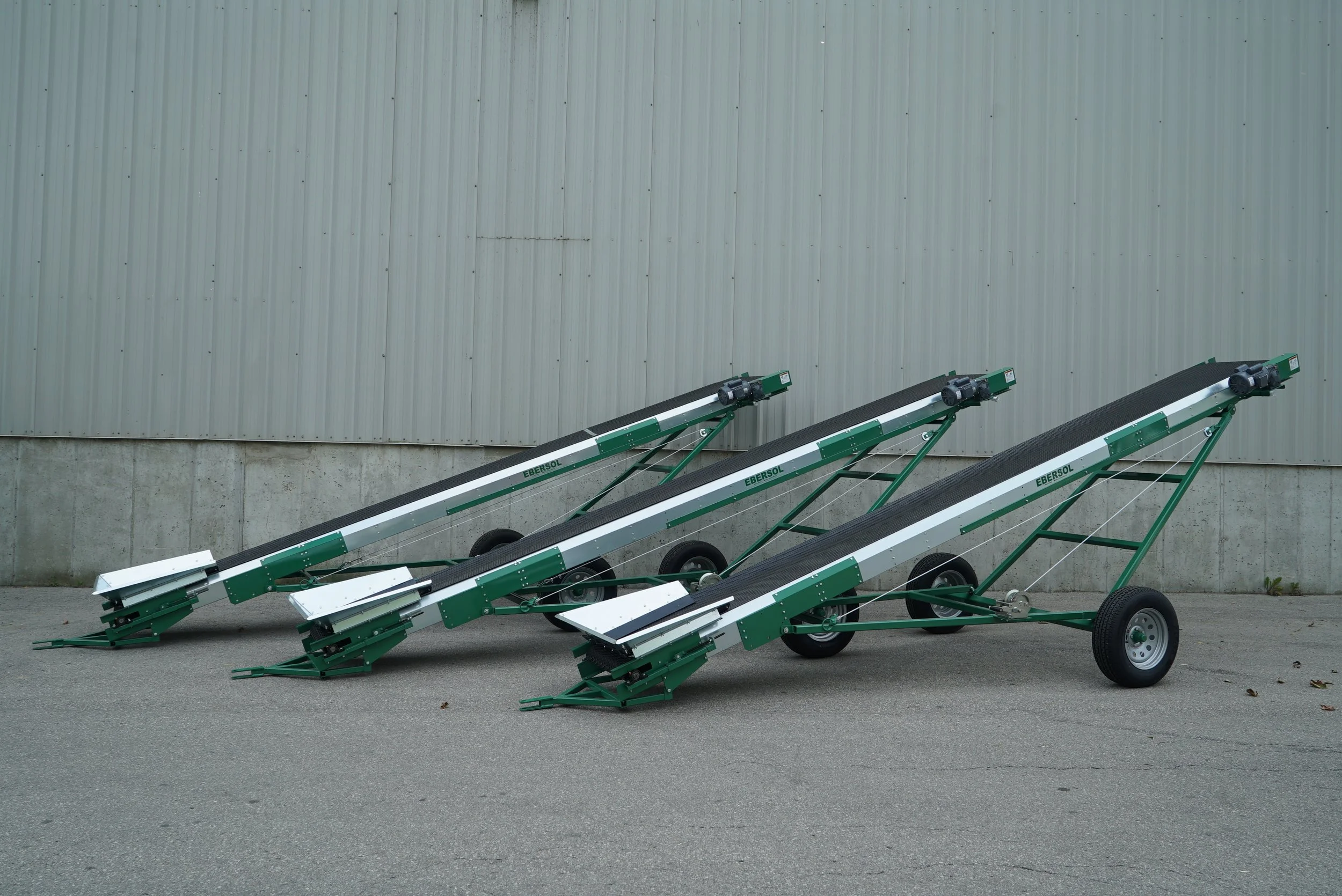 Three belt conveyors lined up in a row.
