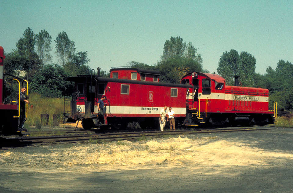 RRRR No. 10 in service with locomotive No. 5, wearing an earlier paint variation with a grey logo. This was later changed to black, and No. 10 was the only RRRR caboose to receive a logo of any sort. (Charles Belt collection, Rochester & Genesee Valley Railroad Museum)