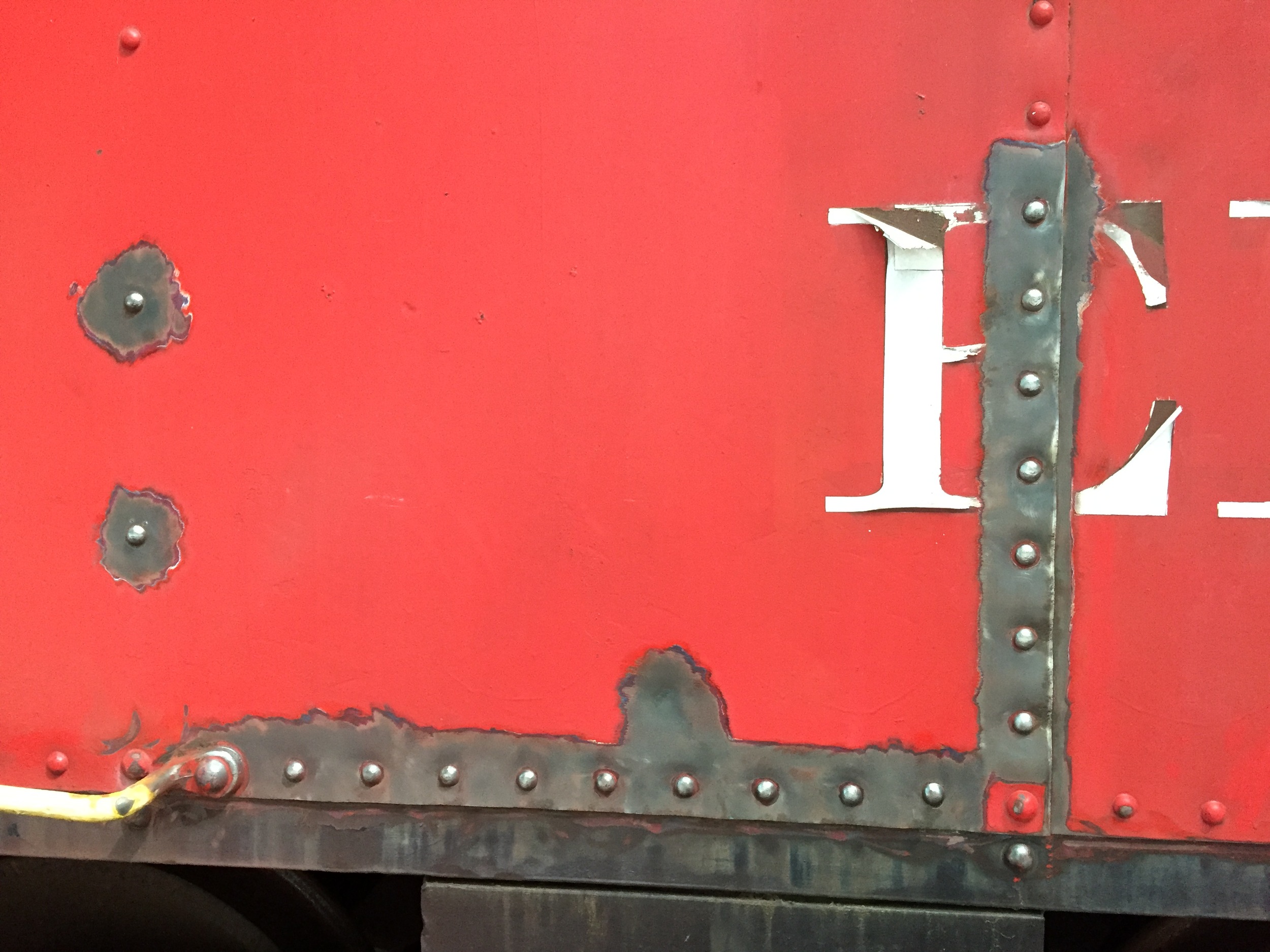 This June 12, 2016 photo shows some of the detailed paint removal and prep work being undertaken around all of No. C330's rivet lines. (Rudy Garbely photo)