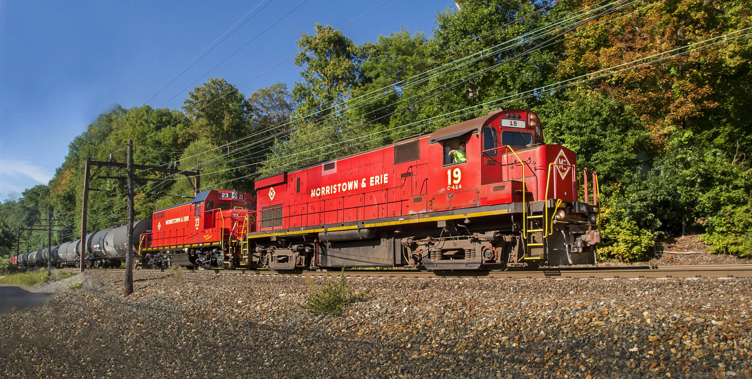 No. 19 is the sole power for this interesting consist rolling through Mt. Tabor, NJ on September 17, 2015. In tow is recently repainted M&E No. 23 and Tri-State's four cabooses, all bound for the URHS yard in Boonton, NJ. (Bill Bossert photo)