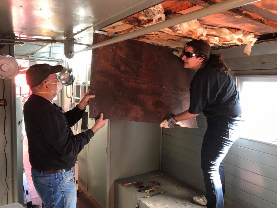Pete Van Seggern and Laura take down a section of the ceiling.