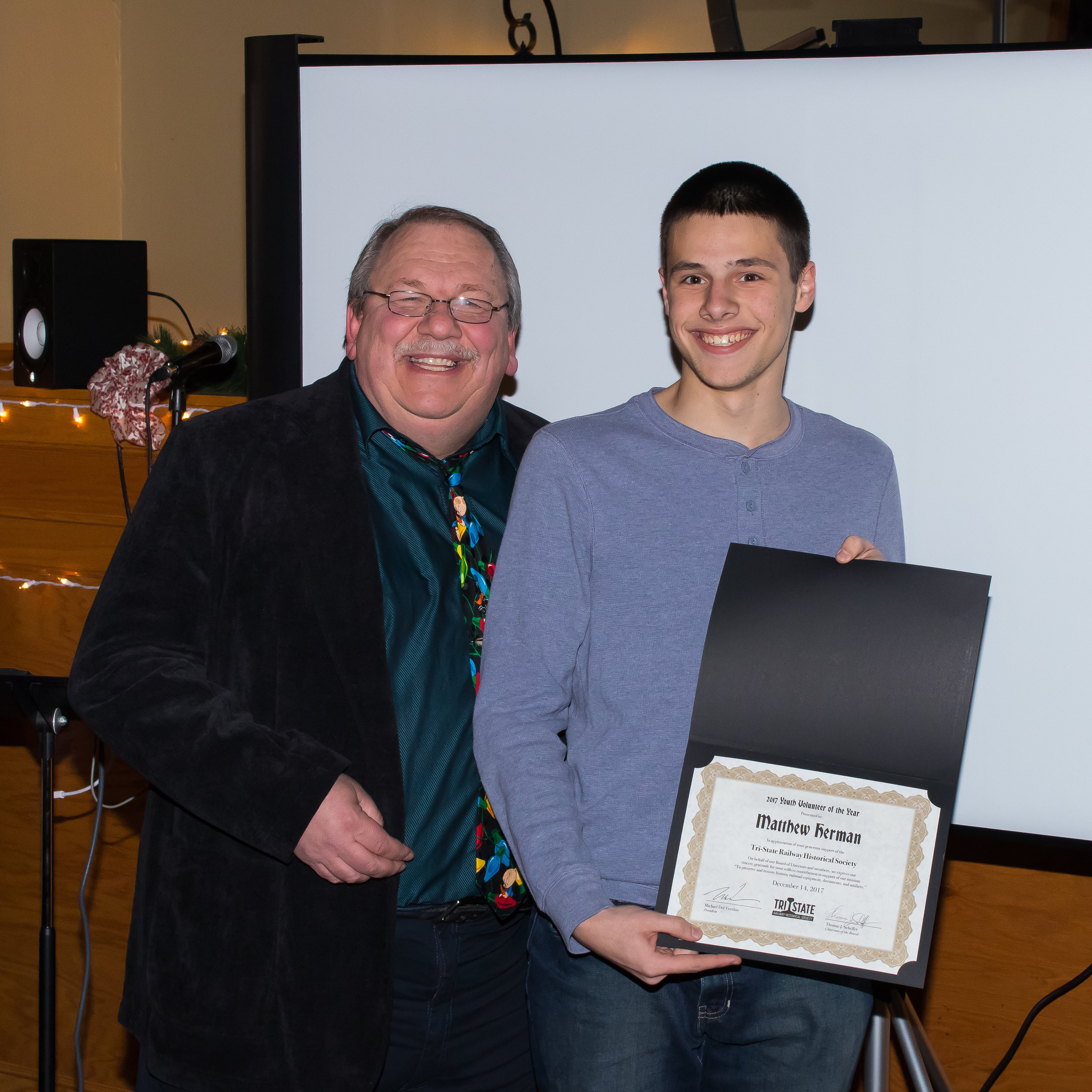  President Michael Del Vecchio with presenting member Matthew Herman with the "Youth Volunteer of the Year" Award 