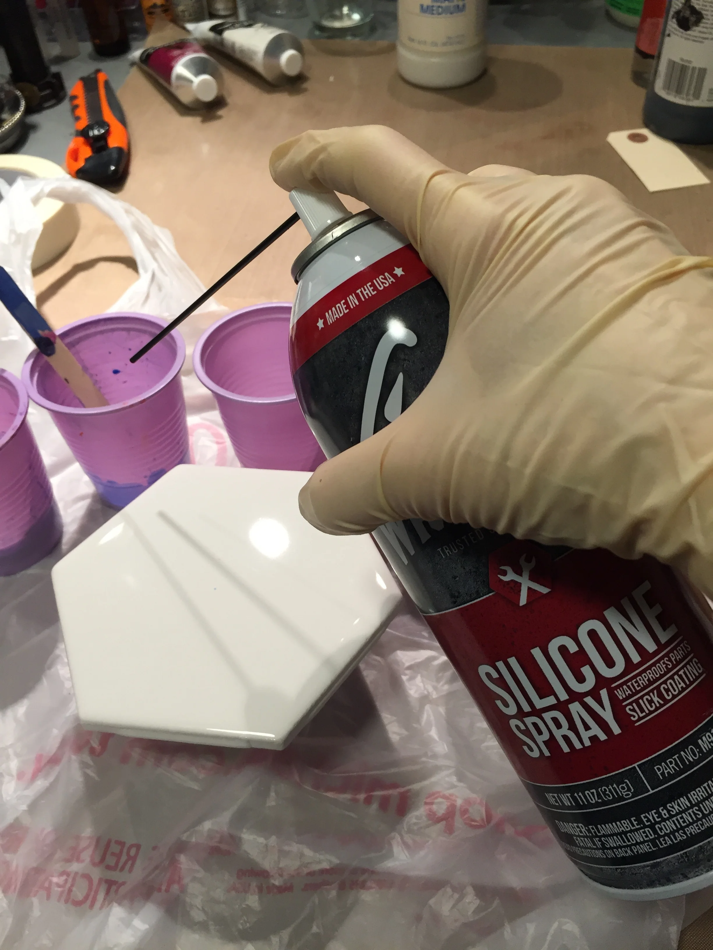 Give your prepared cups a squirt of silicone. You do not need to add silicone to every color. Experiment and decide what outcome you want to achieve. Mix silicone ONLY slightly into your paint mix (I make an X with my stirring stick).