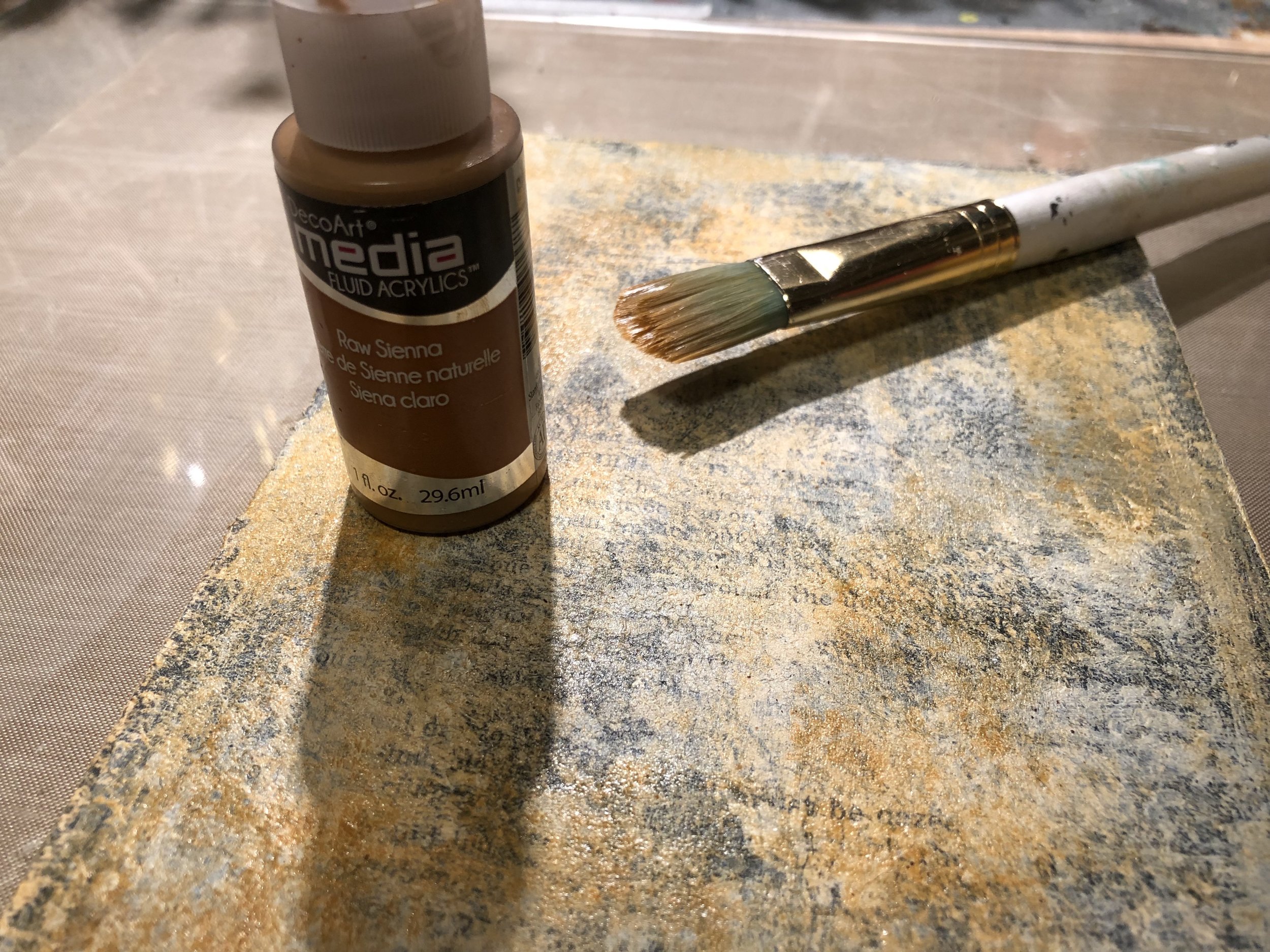 Brush a light layer of DecoArt Media Fluid Acrylic in Raw Sienna.