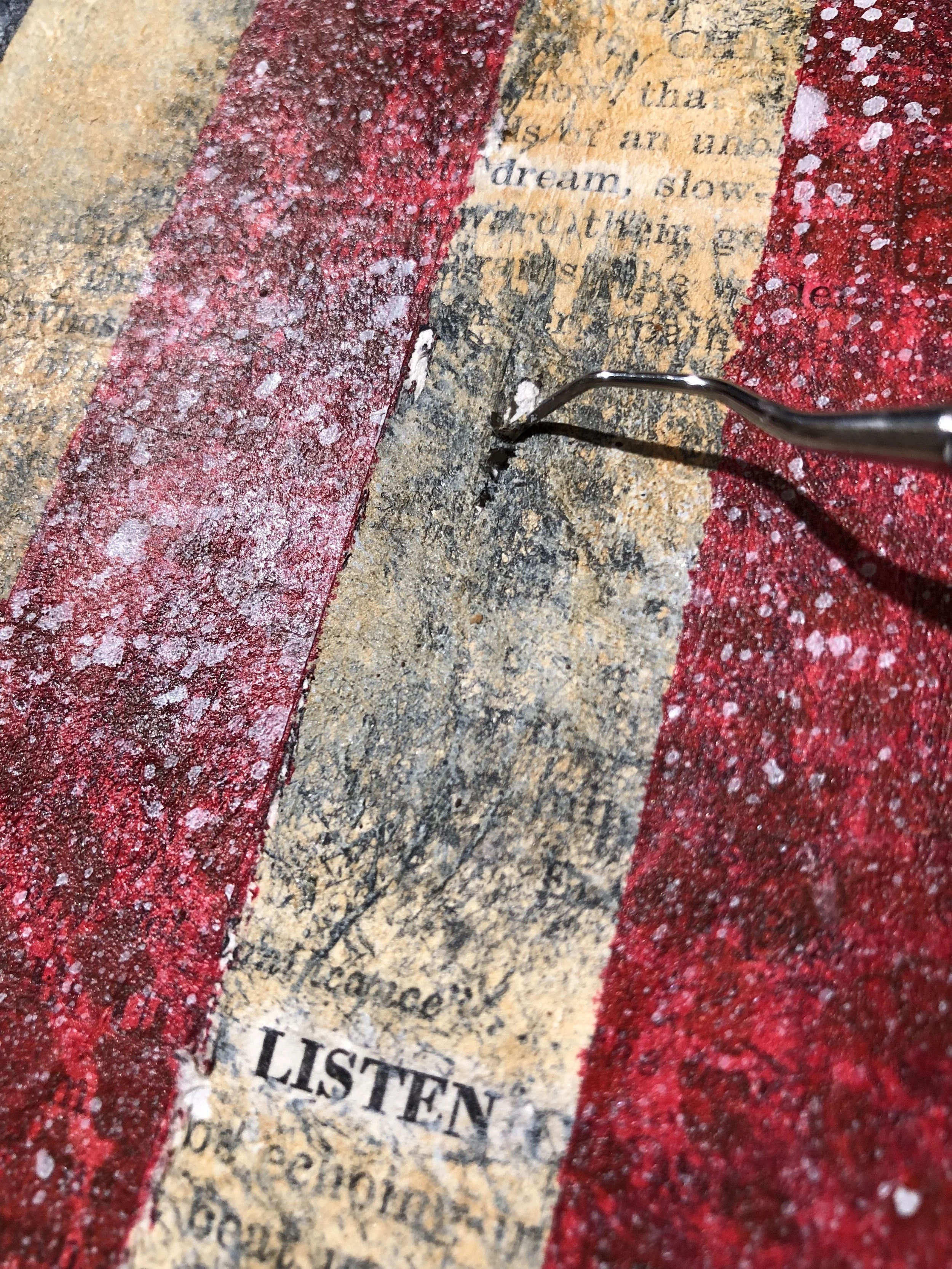 Gently pull off masking tape and reveal your ‘American Dream’ by removing paint over select words with a cotton swab and rubbing alcohol. Grunge up your light stripes with a sharp tool or needle.