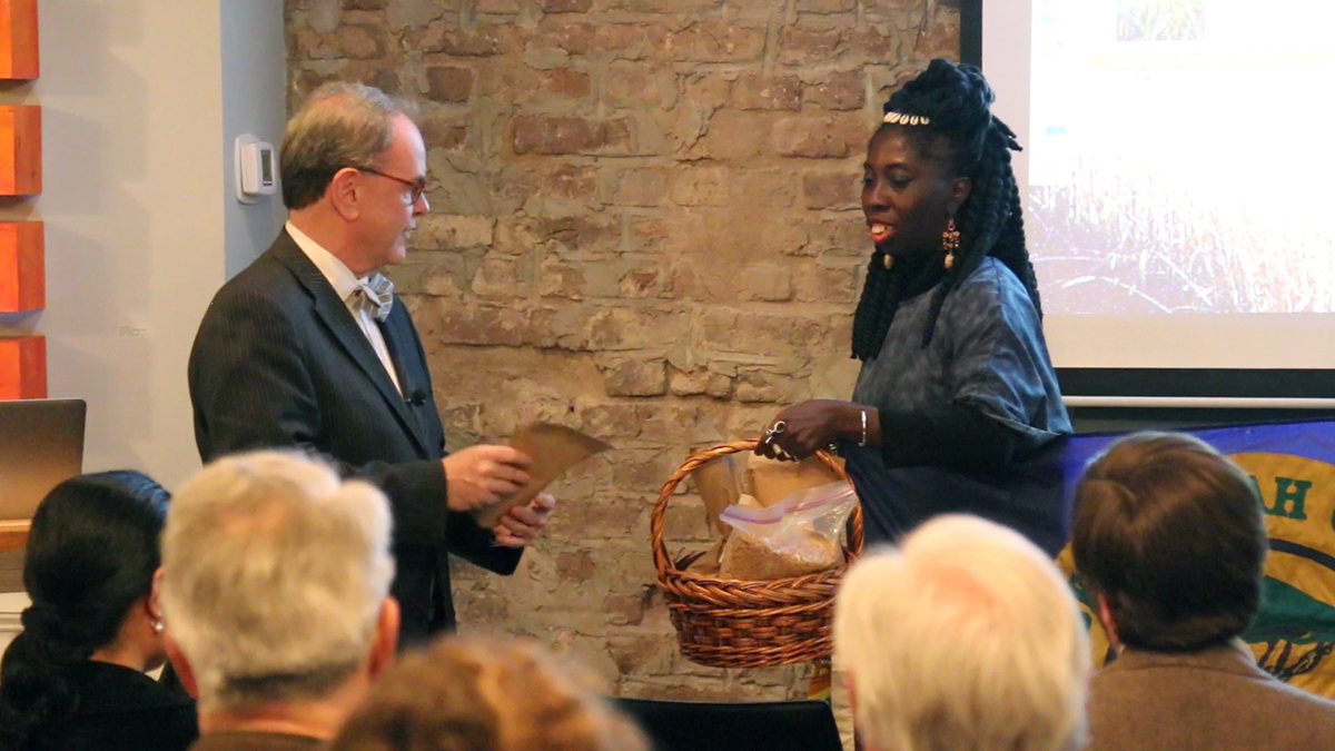 Dr. David Shields presents Queen Quet with seeds for repatriation