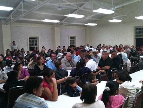 Part of the crowd waiting in anticipation, including the president of Magdalena in the light blue shirt and glasses: