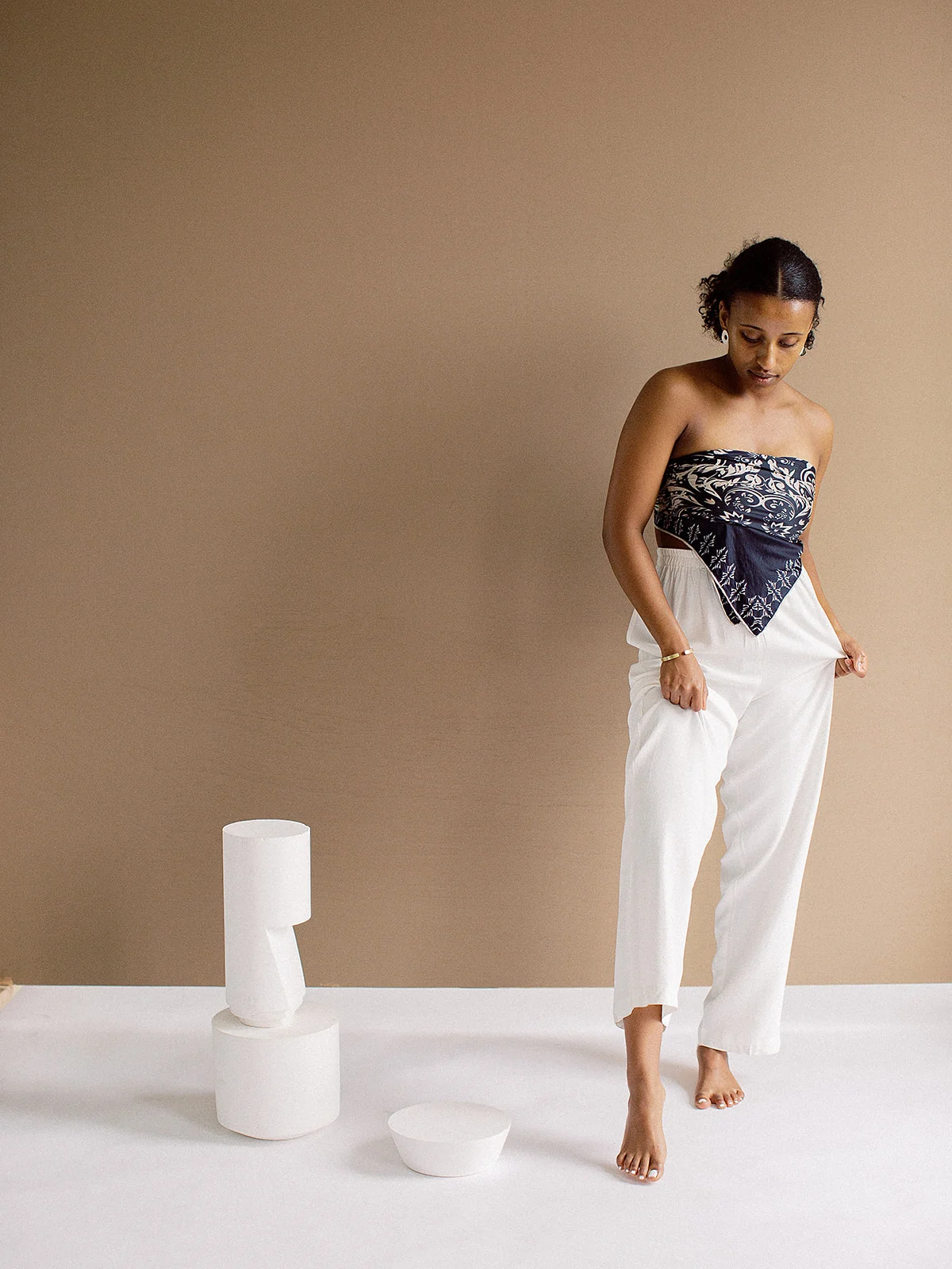 Porcelain Earrings Next To White Sculptural Forms