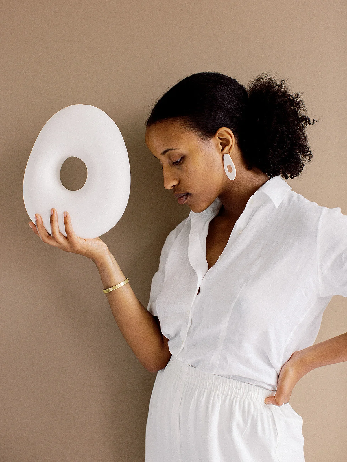 White Monochromatic Outfit With Circular Sculpture and White Organic Shaped Earrings Made of Porcelain and Gold Filled Backings