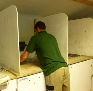 Volunteer Tom gets down to the nitty gritty - papering night boxes in the mews room