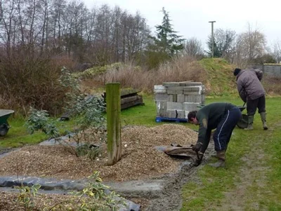 Andy feeds in the last of the concrete footings by hand - phew!