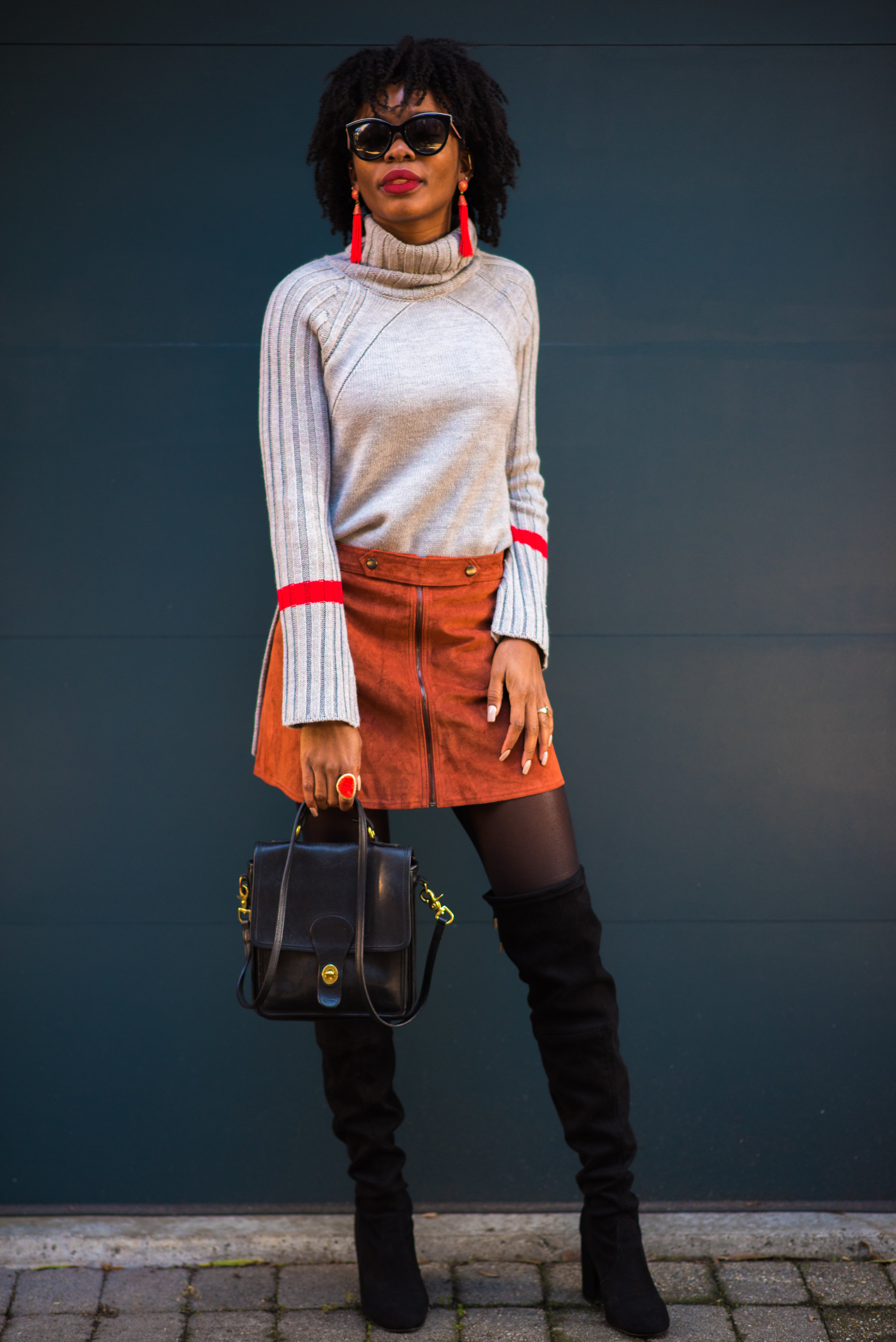 Sweater: Le Tote, Skirt: Forever 21, Boots: Steve Madden; Earrings: Le Tote; Sunglasses: Dolce &amp; Gabbana