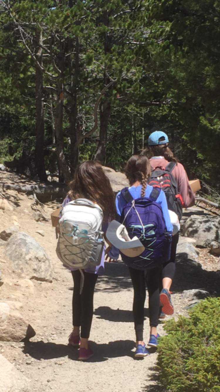 These two girls, after being baptized in a mountain lake, followed their leader, held hands and sang worship songs all the way back to the bus.