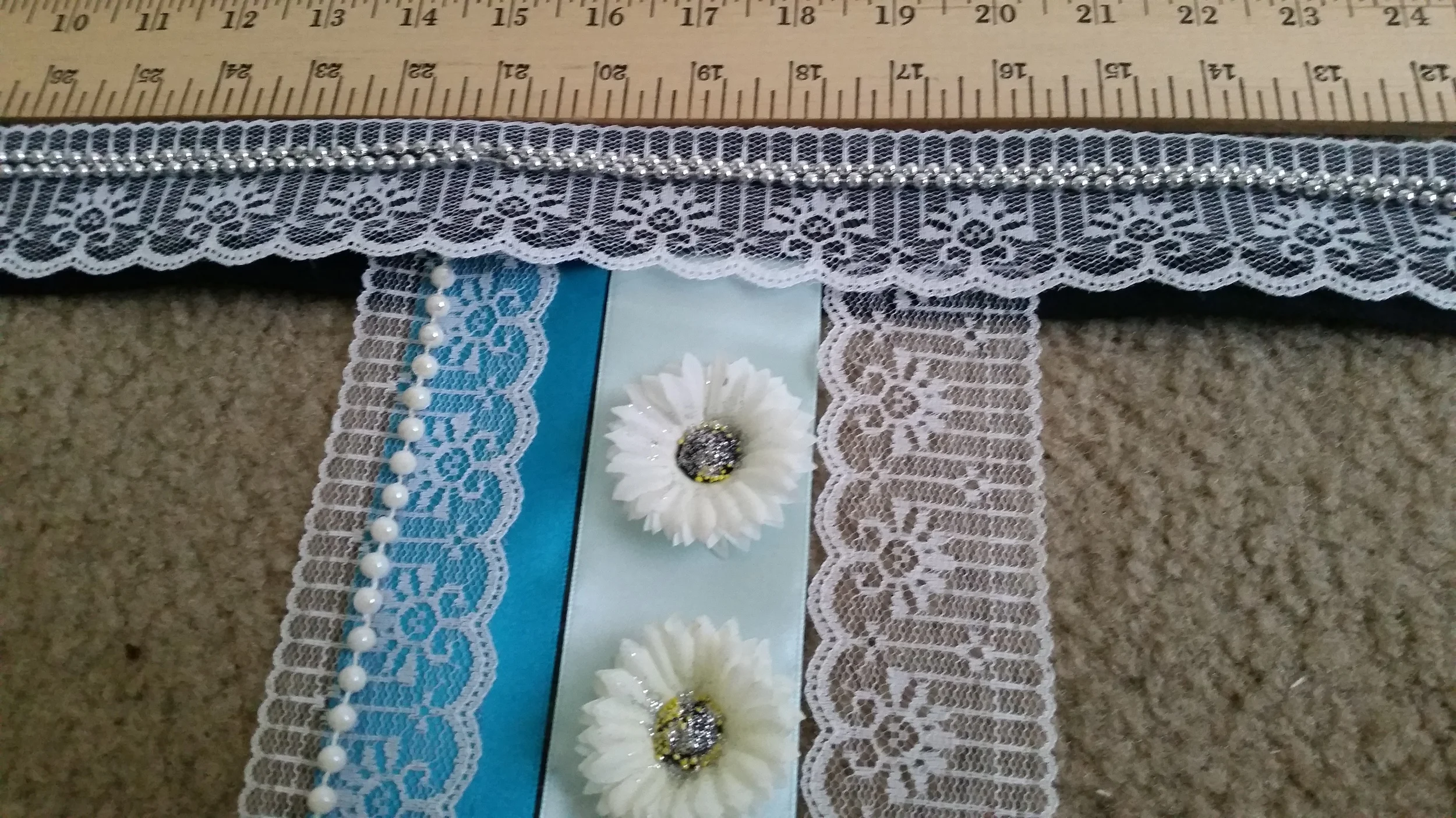 I laid the ornate silk ribbons between the folded halves of the muslin strip.
