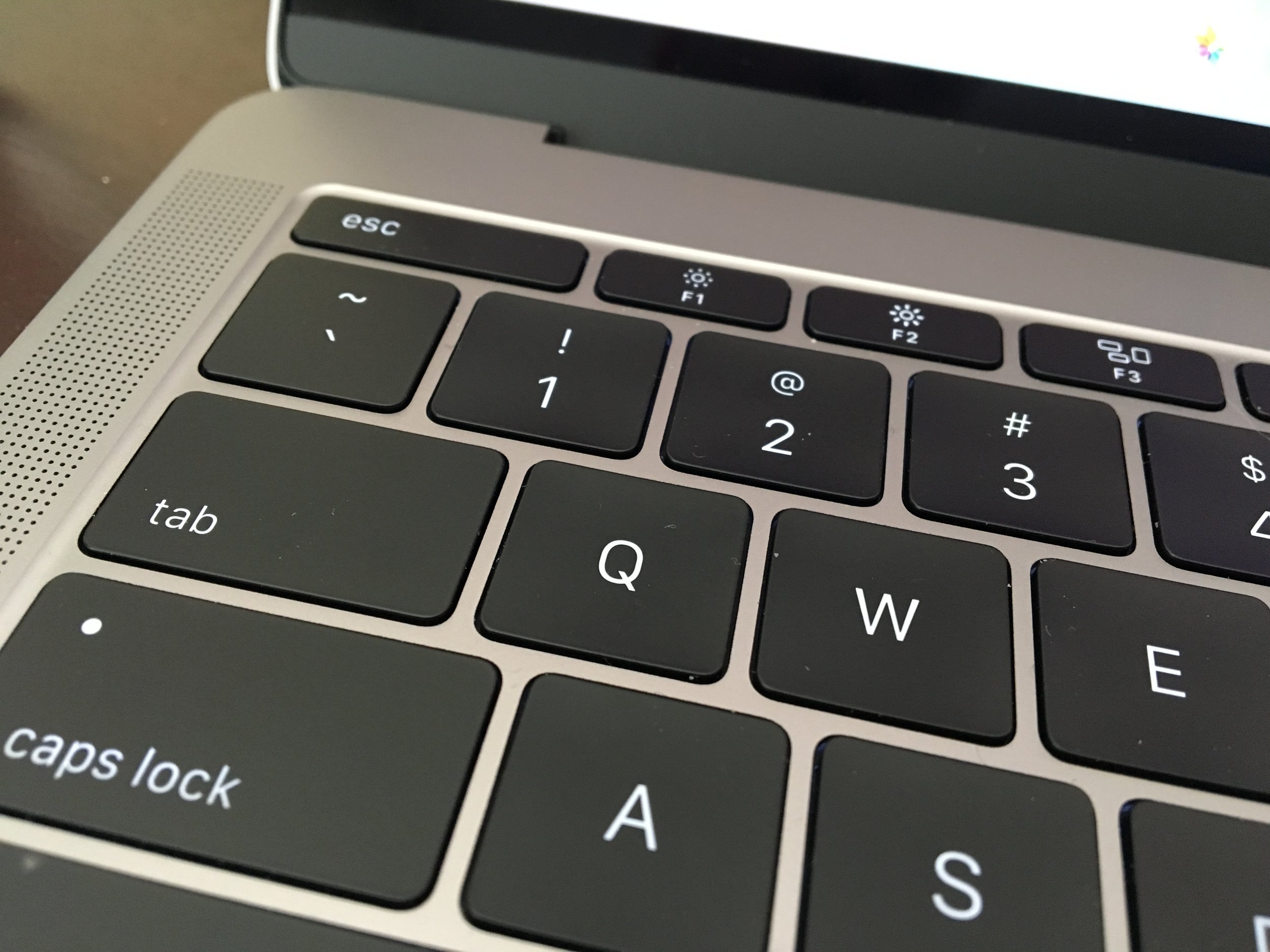 0.5 mm of travel. They keys are raised enough that you can find the right keys comfortably with touch typing, however.